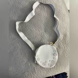 Round crossbody bag with floral embellishment